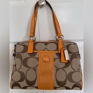 Signature Coach Purse in tan and orange accents.